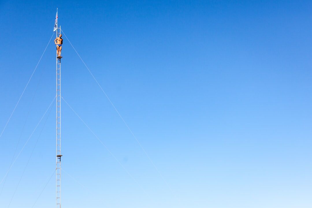 Technician installing a beam antenna on a satellite truck